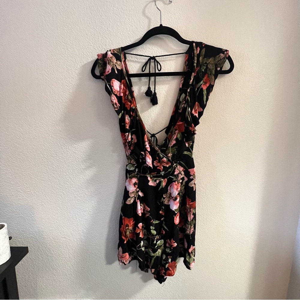 Floral romper with deep neckline.